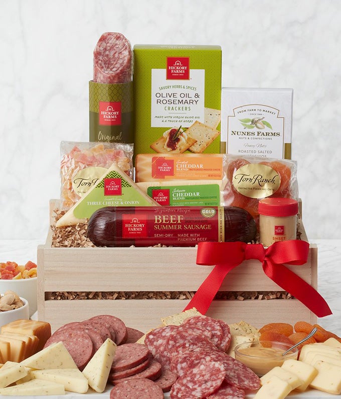 Large wooden gift crate with sausage, cheeses, crackers, pistachios, dried fruit and more