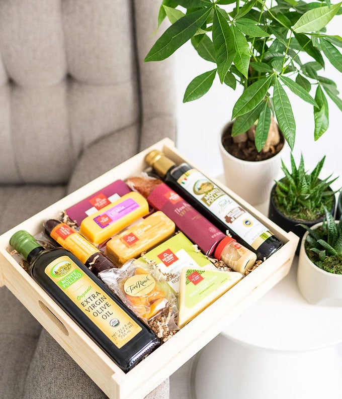 Wooden crate delivered with summer sausage, cheese, dried fruit, olive oil, nuts and more gourmet gifts