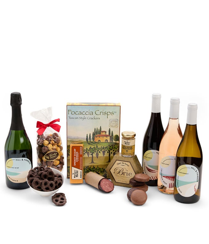 Four bottles of wine delivered with gourmet treats in this wine gift basket