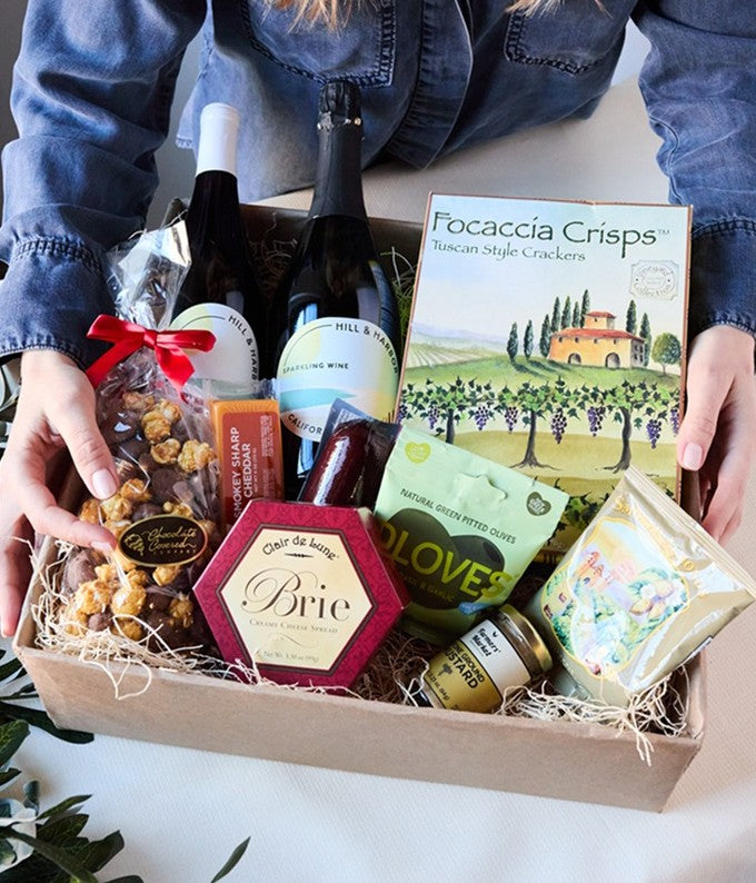 Close up of the California white wine and red wine Charcuterie gift basket with cheeses, meat and crackers