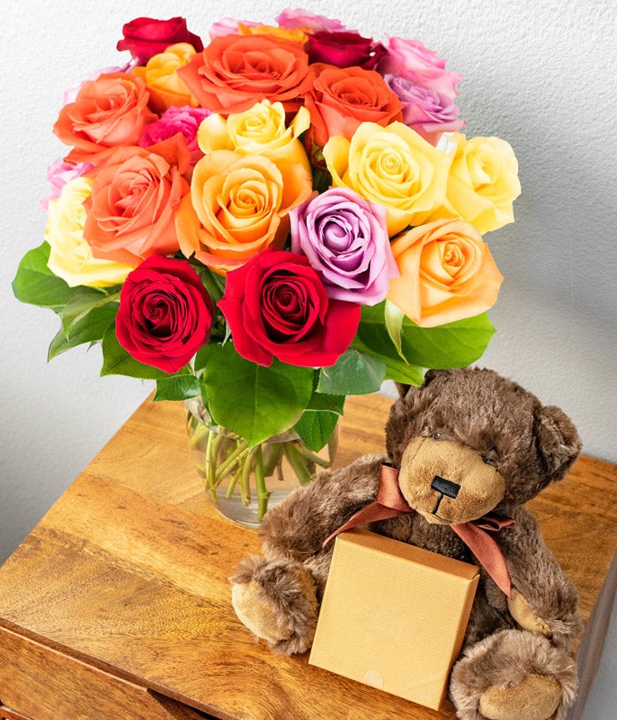 24 brightly colored roses delivered with a plush teddy bear and chocolates