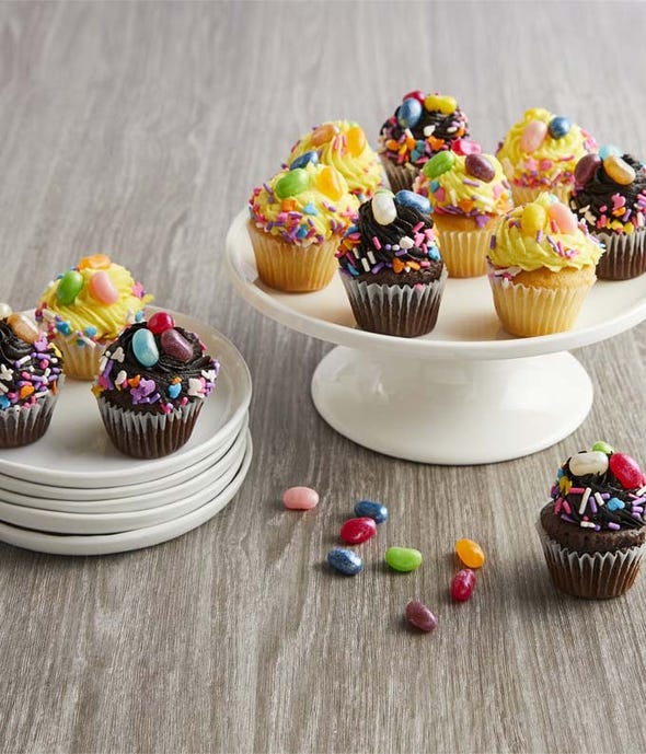 Dozen cupcakes topped with frosting and candy for delivery