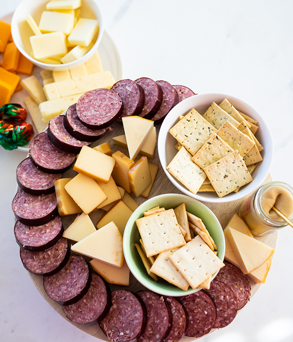 Large Hickory Farms gift basket with three types of sausage, five cheeses and crackers