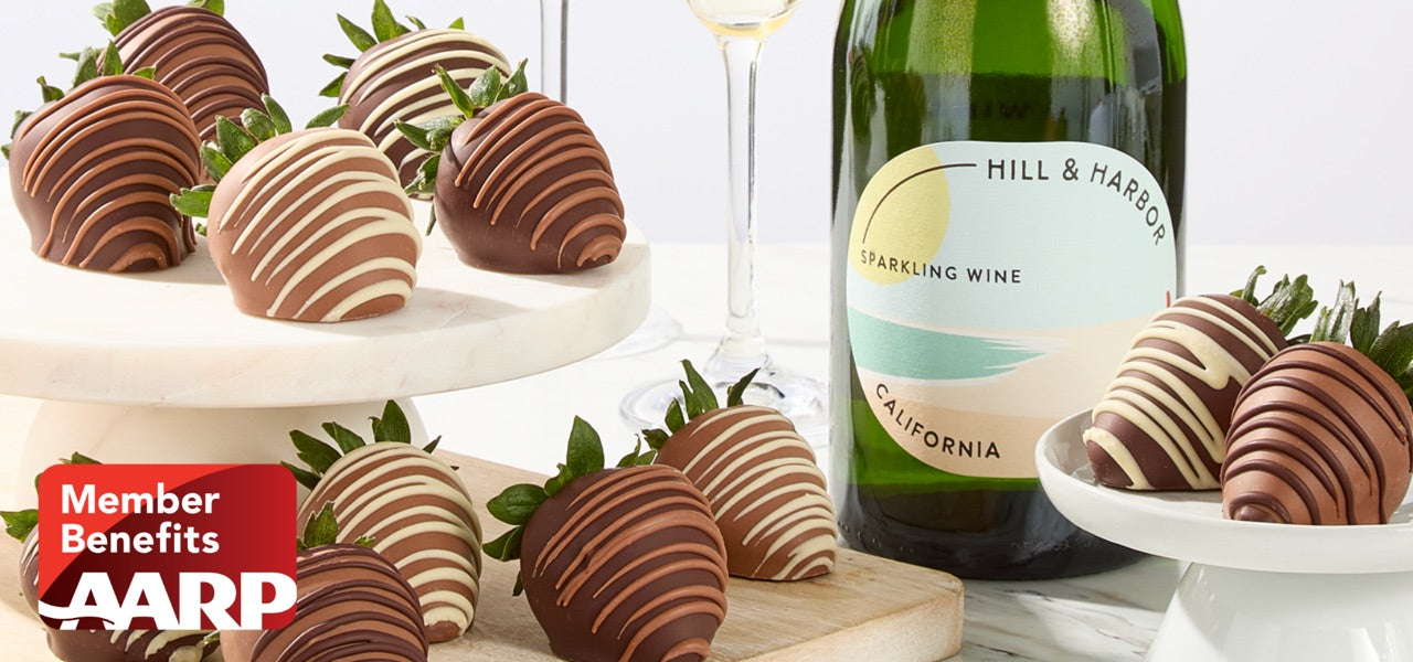 Chocolate-covered strawberries and sparkling wine with the AARP Member Benefits logo
